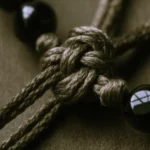 Artisan Cord by Yuano: A macro study of hand-knotted silk representing unseen strength and sacred integrity.