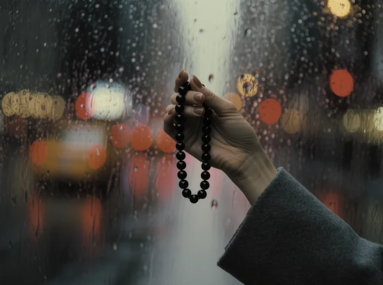 The Portable Altar: Finding Stillness in the Pulse of the City 5 Portable Altar by Yuano: A handcrafted obsidian necklace held against the blurred lights of a rainy city.