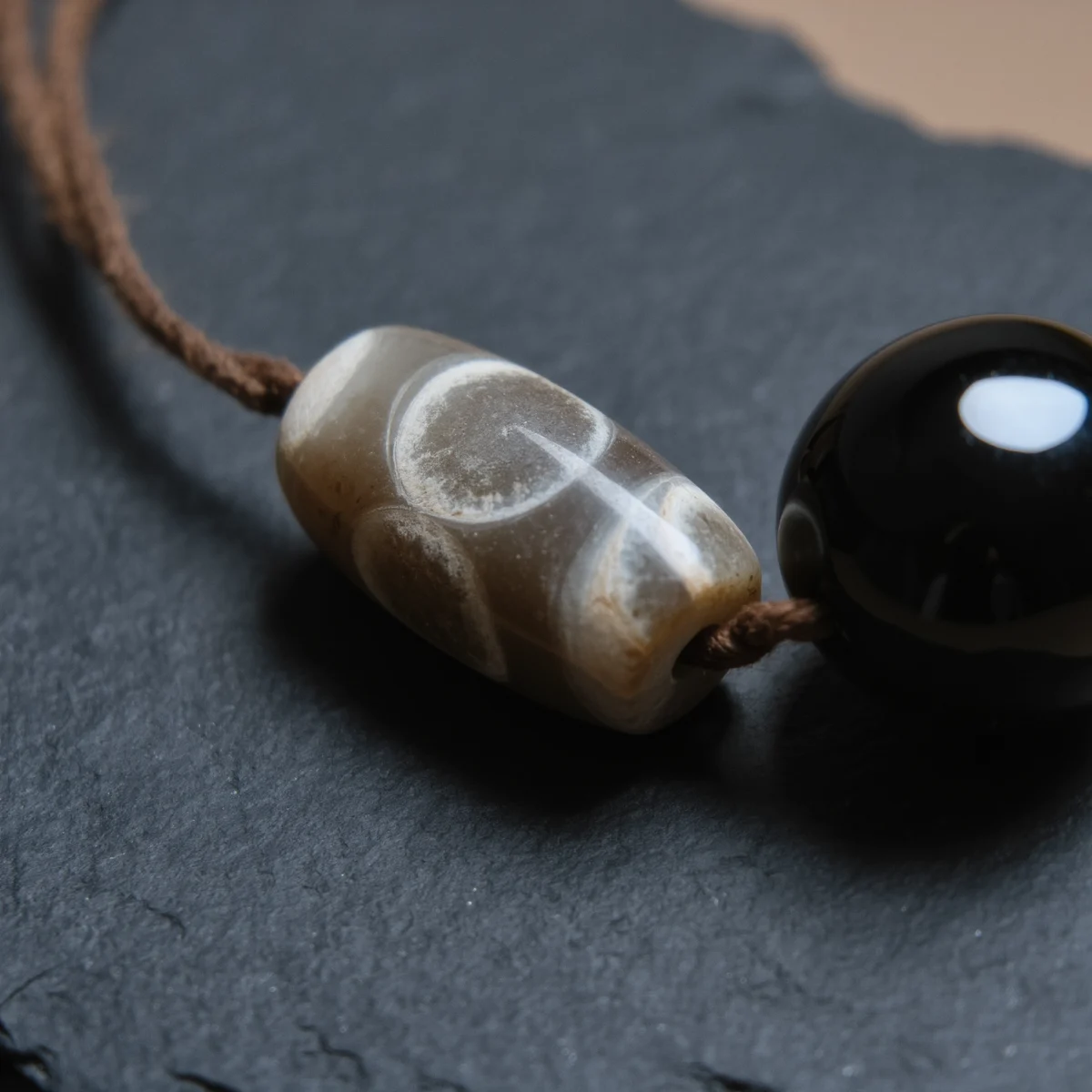 Covenant No. 01 — Mineral Covenant Detail Covenant No. 01 macro detail revealing the etched geometric marks of Tibet Dzi and the glassy luster of obsidian.