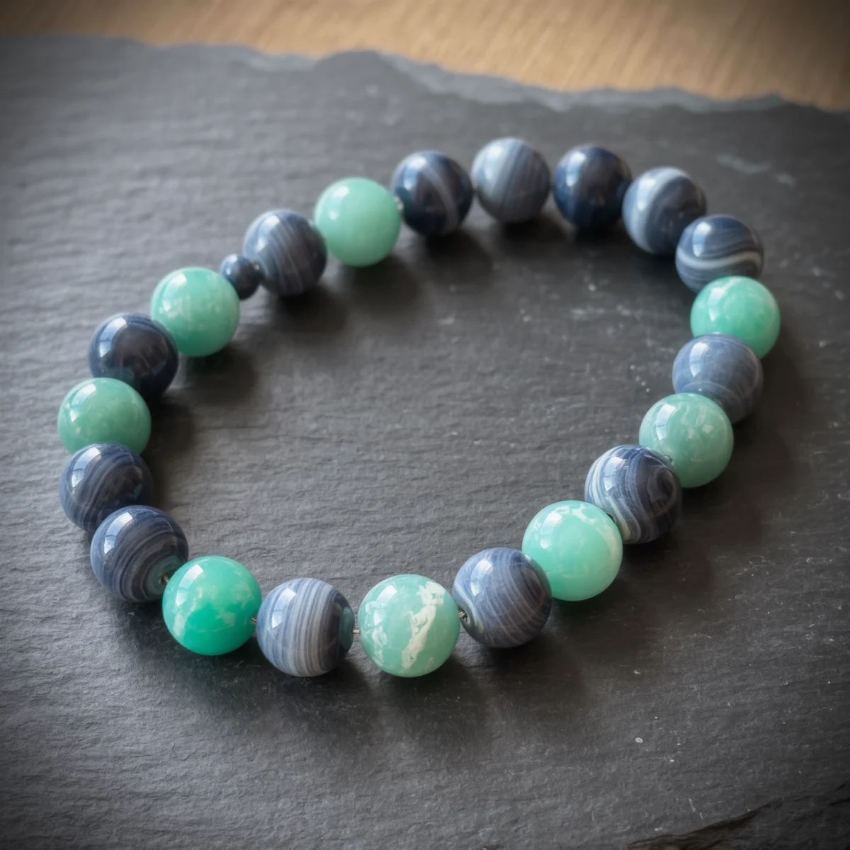 Fluidity No. 08 — Flowing Grace Main Perspective Fluidity No. 08: Flowing Grace hand-knotted necklace featuring Ili Blue Agate and Fujian Amazonite on slate.