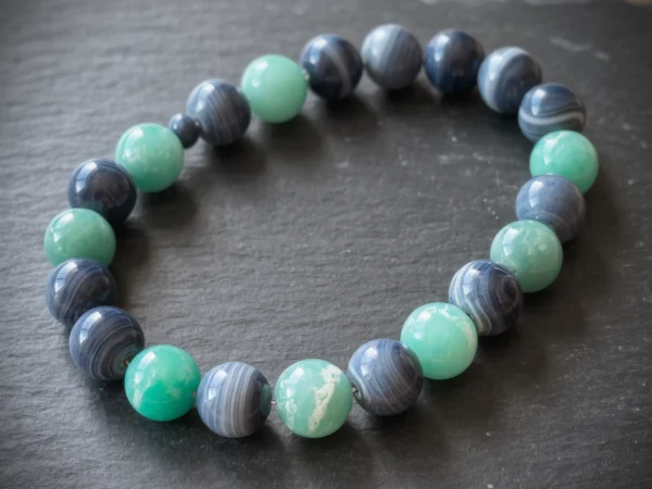 Fluidity No. 08 — Flowing Grace Main Perspective Fluidity No. 08: Flowing Grace hand-knotted necklace featuring Ili Blue Agate and Fujian Amazonite on slate.