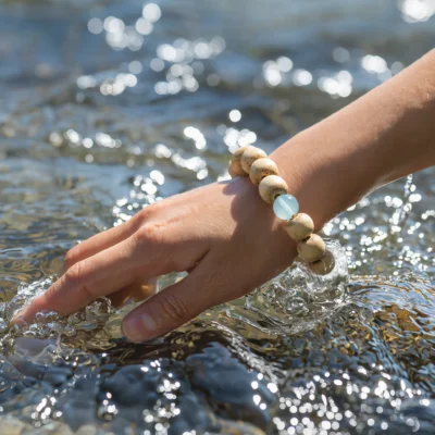 Fluidity No. 10 — Lifestyle Aquatic Perspective Fluidity No. 10: Pure Drift bracelet worn by a model splashing in clear water, highlighting its organic movement.