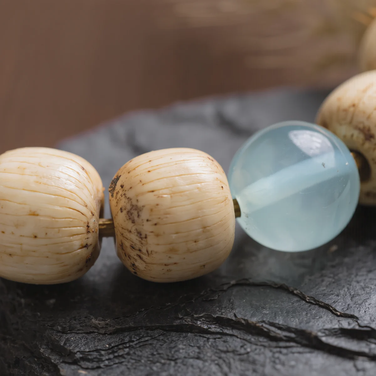 Fluidity No. 10 — Organic Material Witness Fluidity No. 10 macro detail showing the creamy organic surface of Bodhi Root and the crystalline depth of Aquamarine.