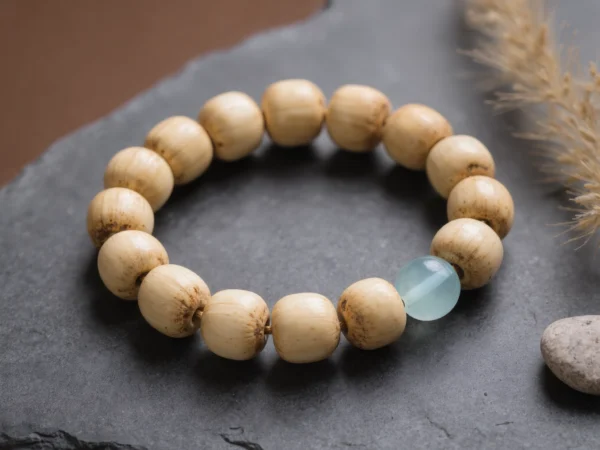 Fluidity No. 10 — Pure Drift Main Perspective Fluidity No. 10: Pure Drift hand-knotted bracelet featuring Hainan Bodhi Root and Xinjiang Aquamarine on slate.