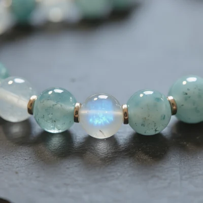 Fluidity No. 01 — Macro Material Witness Fluidity No. 01 macro detail highlighting the ethereal blue adularescence of Sichuan Moonstone and the oceanic clarity of Xinjiang Aquamarine.