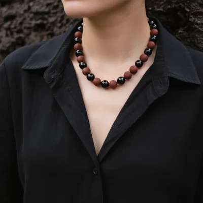 Fortress No. 01 — Lifestyle Observational Strength Fortress No. 01: Iron Guard necklace worn by a model in a black shirt against a dark textured background.