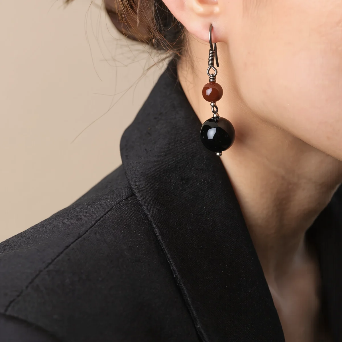 Fortress No. 03 — Lifestyle Observational Poise Fortress No. 03: Eternal Guard earrings worn by a model in a sharp black blazer against a neutral background.