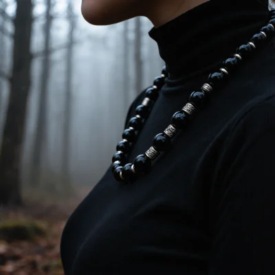 Fortress No. 07 — Lifestyle Observational Poise Fortress No. 07: Night Sentinel necklace worn by a model in a black turtleneck within a misty, dark forest.