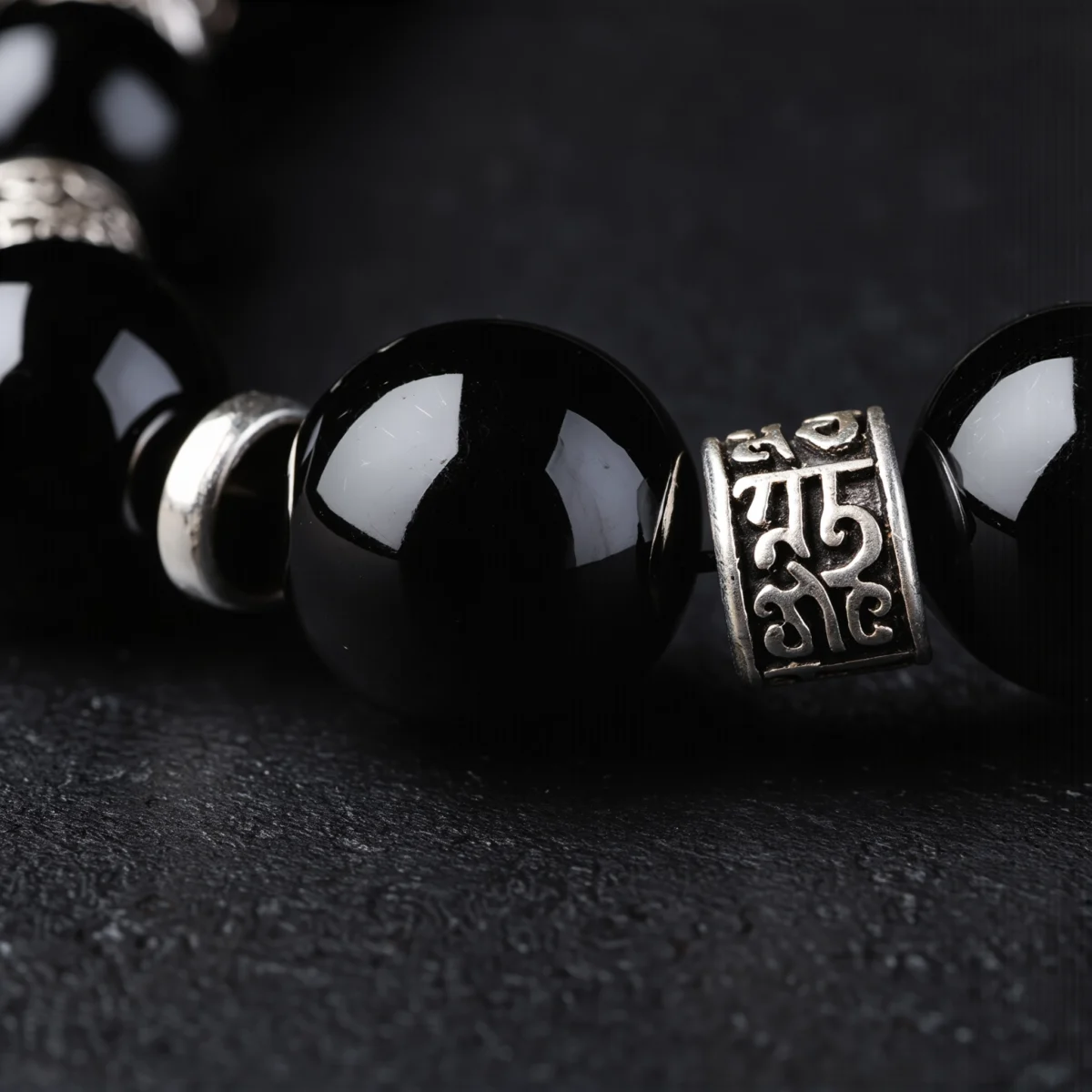 Fortress No. 07 — Mineral Fortification Detail Fortress No. 07 macro detail revealing Sanskrit-style engravings on silver and the glassy void of Tibet Obsidian.