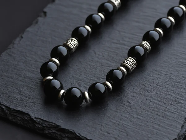 Fortress No. 07 — Night Sentinel Primary Narrative Fortress No. 07: Night Sentinel hand-knotted necklace featuring Tibet Obsidian and Mantra-engraved silver.