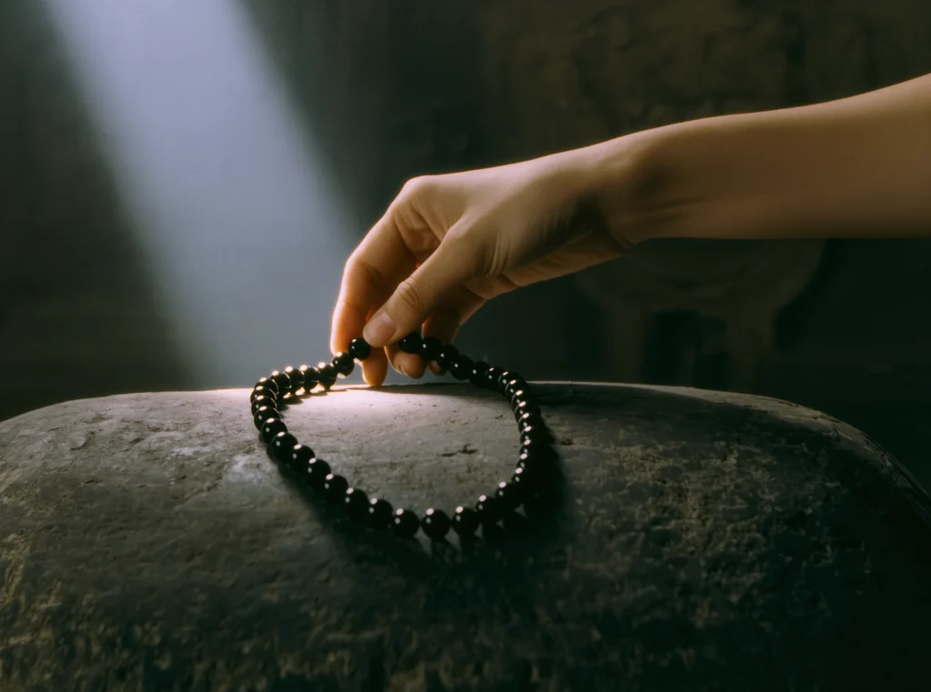 About Us 12 Handcrafted Jewelry by Yuano: A sacred obsidian relic illuminated by observational light.