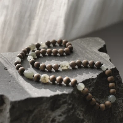 Origin No. 01 — The Relic of Ancient Soil Product Image Origin No. 01: Hand-knotted necklace featuring Xinjiang Nephrite Jade and Hainan Sandalwood by Yuano.