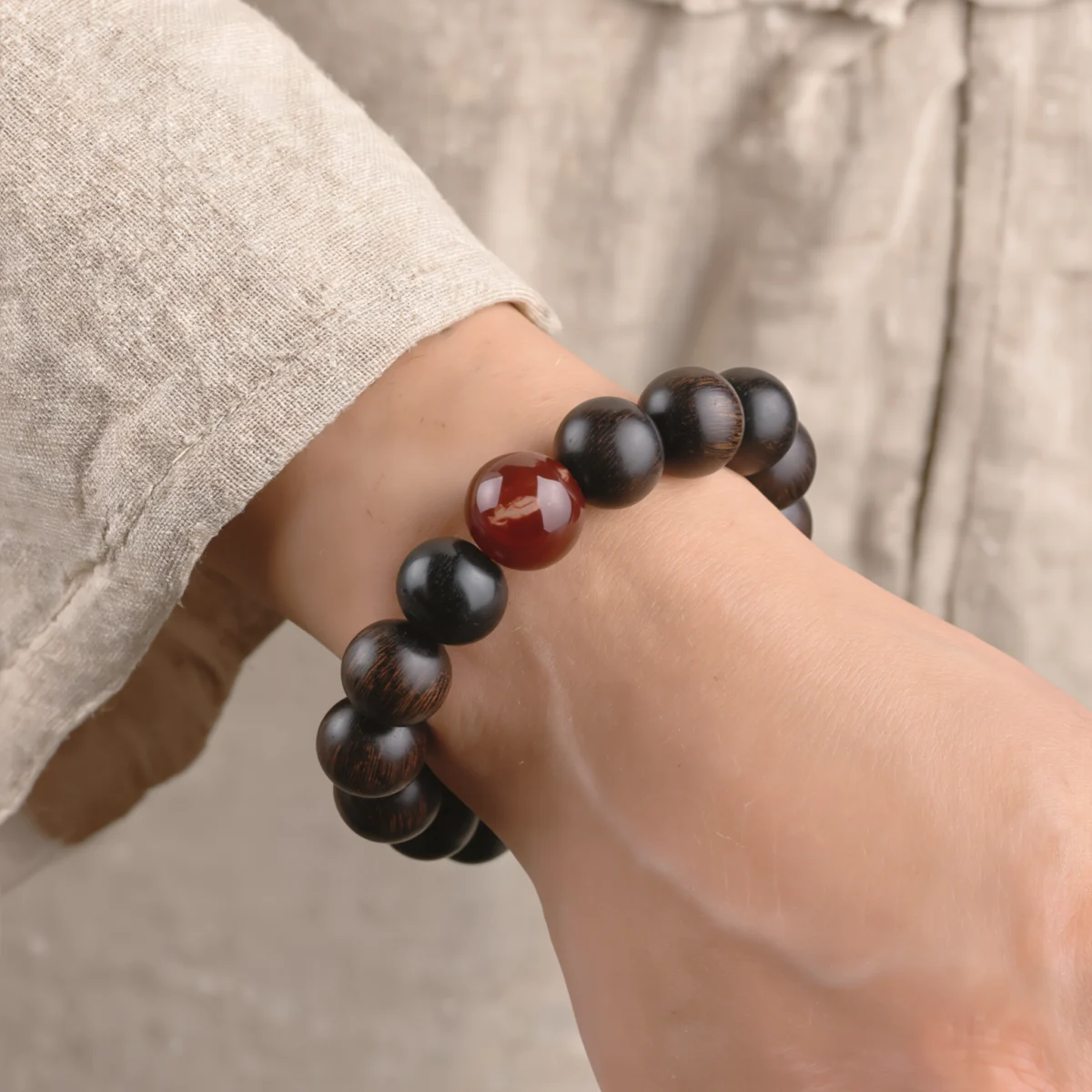 Origin No. 02 — Lifestyle and Wearing Perspective Origin No. 02 Tree of Life bracelet worn on a wrist, showcasing the scale of Nanhong Agate and Sandalwood beads.