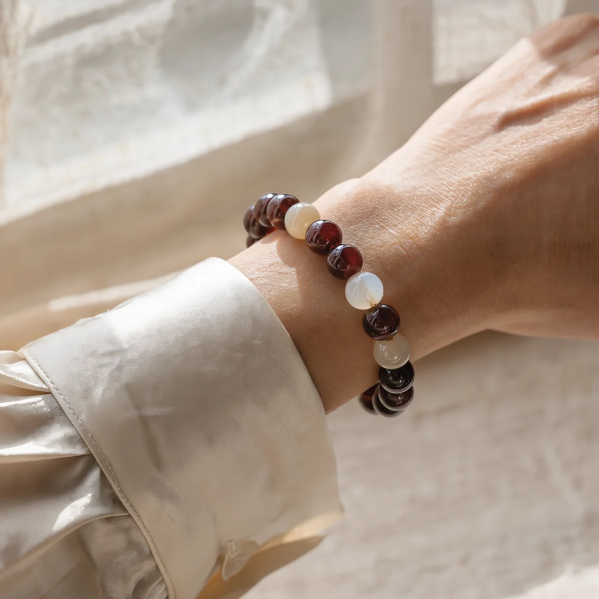Origin No. 03 — Lifestyle Wearing Perspective-pulse-bracelet-on-wrist-lifestyle.webp Origin No. 03: Earth's Pulse bracelet worn on a wrist, showcasing the contrast between Nanhong and White Agate.