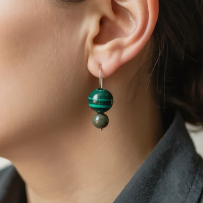 Origin No. 04 — Lifestyle Wearing Perspective Origin No. 04: Valley Whisper earrings worn by a model, demonstrating the natural drape and cinematic light of the malachite beads.
