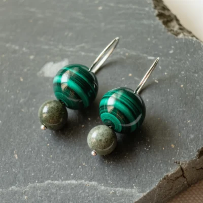 Origin No. 04 — Valley Whisper Main Perspective Origin No. 04: Valley Whisper hand-knotted earrings featuring Anhui Malachite and Zhejiang Qingtian Stone on a bone-white background.