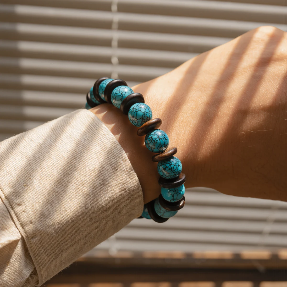 Origin No. 06 — Lifestyle Wearing View Origin No. 06: Ancestral Song bracelet worn on a wrist, demonstrating the elegant drape and cinematic light of the turquoise beads.