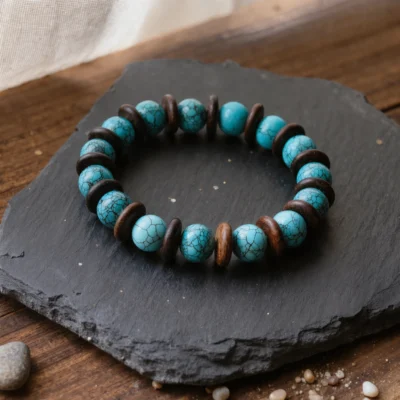Origin No. 06 — Ancestral Song Main Perspective Origin No. 06: Ancestral Song hand-knotted bracelet featuring sky-blue Hubei Turquoise and Aged Hainan Sandalwood on a dark slate.