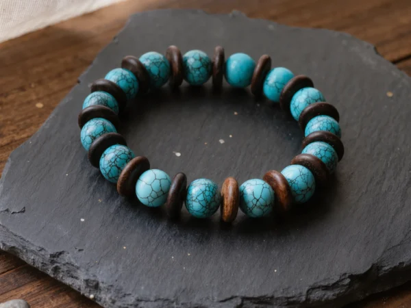 Origin No. 06 — Ancestral Song Main Perspective Origin No. 06: Ancestral Song hand-knotted bracelet featuring sky-blue Hubei Turquoise and Aged Hainan Sandalwood on a dark slate.