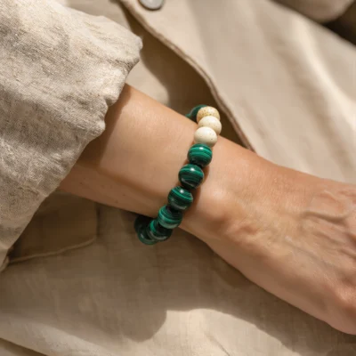 Origin No. 08 — Lifestyle Wearing Perspective Origin No. 08: Sacred Forest bracelet worn by a model, demonstrating the natural drape and vibrant contrast against linen fabrics.