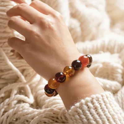 Radiance No. 02 — Lifestyle Radiant Perspective Radiance No. 02: The Inner Hearth bracelet worn on a wrist against a soft, cream-colored knitted background.