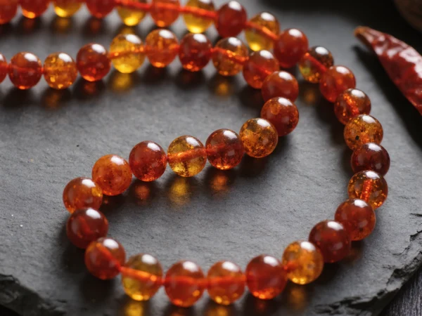 Radiance No. 04 — Flame Seed Primary Narrative Radiance No. 04: Flame Seed hand-knotted necklace featuring Yunnan Tengchong Amber and Sichuan Nanhong.