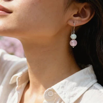 Serenity No. 03 — Lifestyle Observational Poise Serenity No. 03: Drifting Petal earrings worn by a model against a white linen garment in natural golden light.
