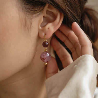 Serenity No. 07 — Lifestyle Observational Poise Serenity No. 07: Quiet Joy earrings worn by a model against a soft silk garment in gentle natural light.