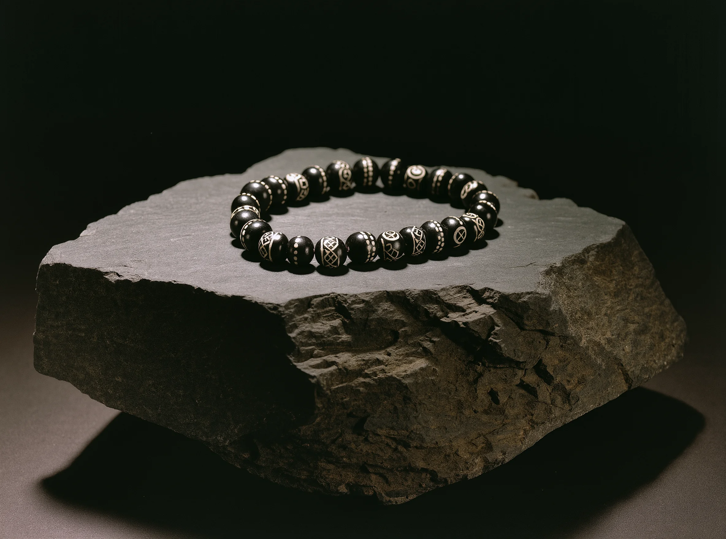 Terms of Service 1 Sovereign Stillness Jewelry Terms: A handcrafted obsidian relic resting on a slate block, symbolizing the unshakeable integrity of our covenant.
