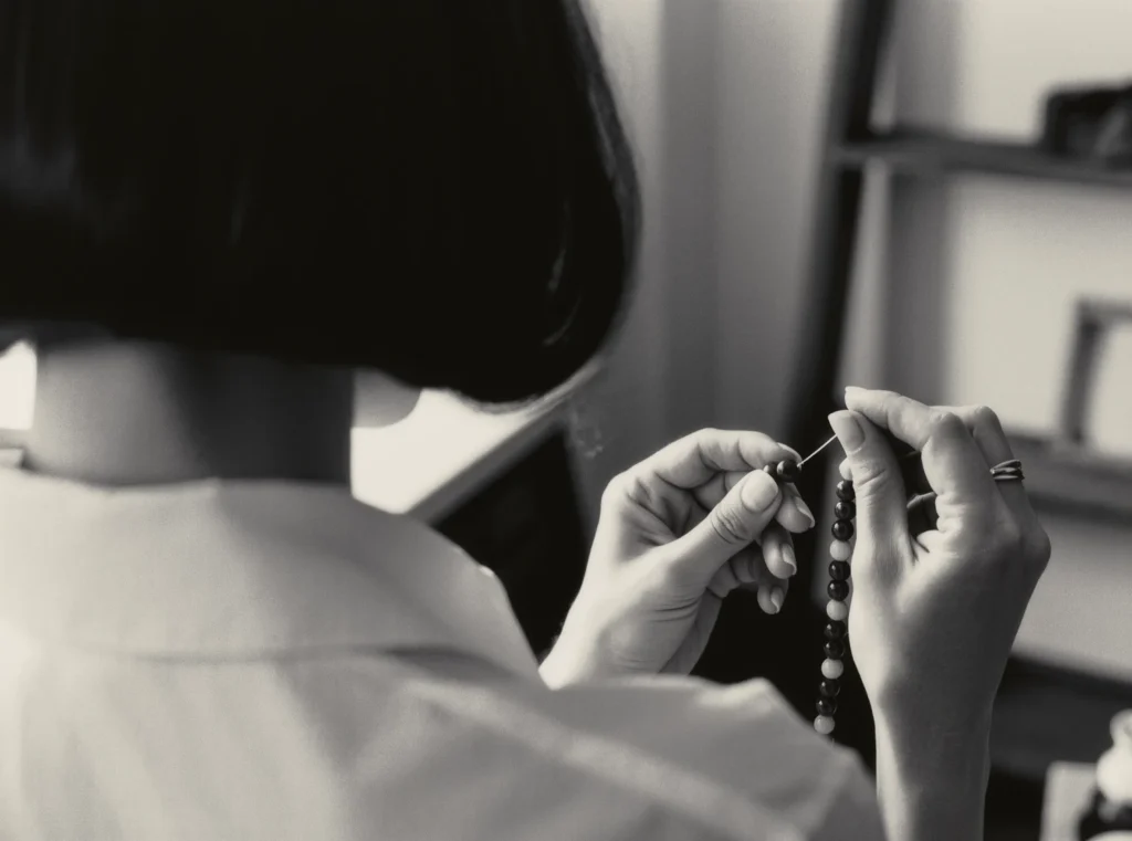 About Us 10 Master Knotter MEI meticulously stringing black obsidian beads in the silent Yuano studio.